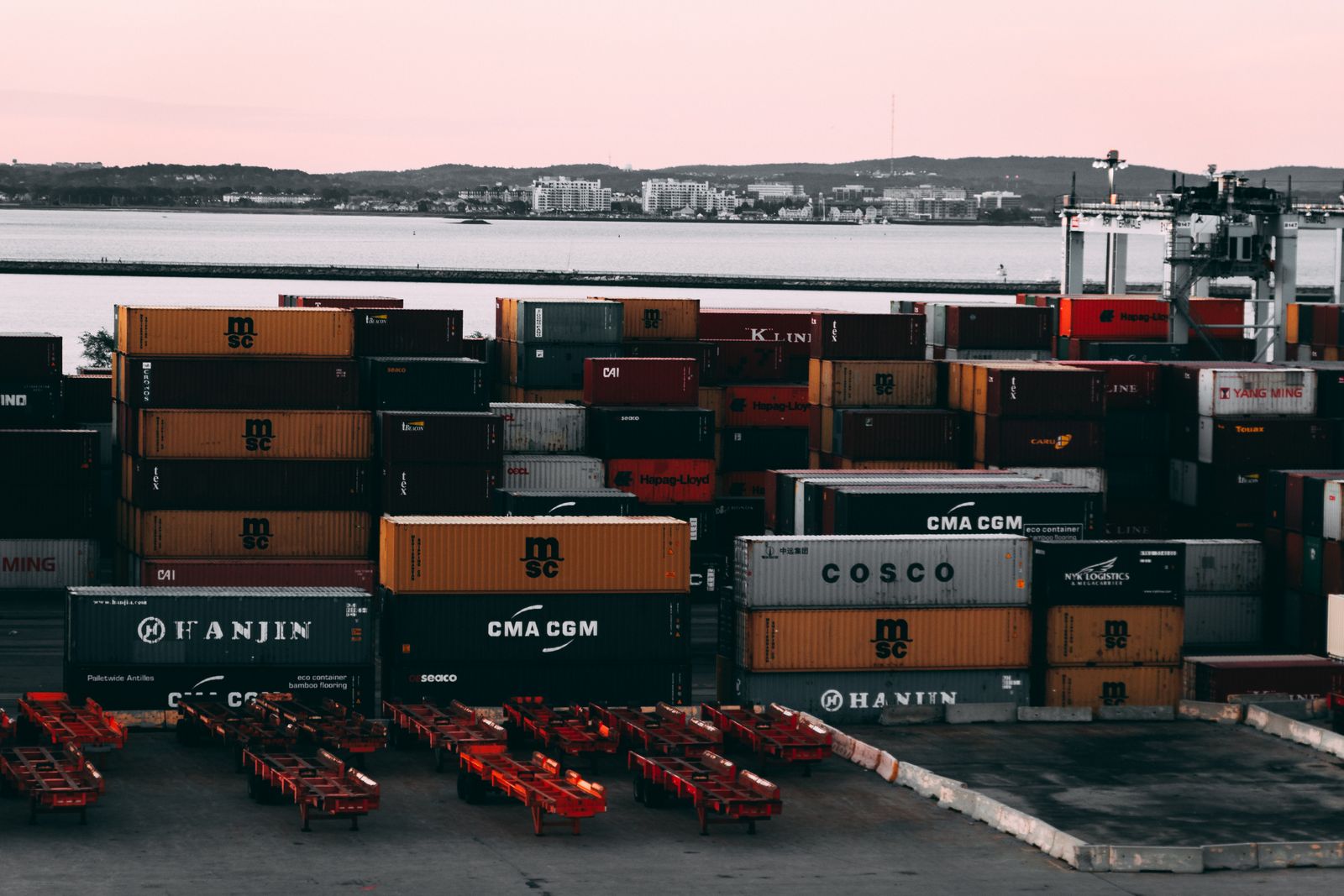 Assorted color cargo containers near a body of water